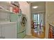 The laundry area features a washer and dryer, with a peek of the adjacent dining room at 26 Cobblestone Crk, Peachtree City, GA 30269