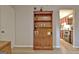 Cozy living room area with natural light, a wooden bookcase, and a view into the updated kitchen at 26 Cobblestone Crk, Peachtree City, GA 30269