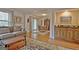 View of living room with hardwood floors, a wet bar area, and a dining room for a great flow at 26 Cobblestone Crk, Peachtree City, GA 30269
