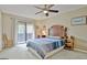 Serene main bedroom with a ceiling fan, access to a private balcony, and natural light at 26 Cobblestone Crk, Peachtree City, GA 30269