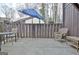 Patio with outdoor chairs, table, umbrella, and wooden fence, perfect for relaxation at 26 Cobblestone Crk, Peachtree City, GA 30269