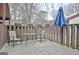 Back patio featuring an umbrella, string lights, chairs, and wood fence at 26 Cobblestone Crk, Peachtree City, GA 30269