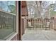 Outdoor patio featuring seating, a glass table, string lights and a wooden fence at 26 Cobblestone Crk, Peachtree City, GA 30269
