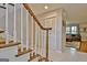View of staircase with wood and white accents and entry hall with multiple storage closets at 26 Cobblestone Crk, Peachtree City, GA 30269