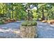 Street view of the community showing cobblestone streets, mature trees and lush landscaping at 26 Cobblestone Crk, Peachtree City, GA 30269