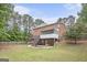 Large backyard with a deck and enclosed patio on a brick traditional style home at 1085 Crown River Pkwy, Mcdonough, GA 30252