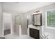 Bathroom featuring a shower, vanity, and a tub with natural light at 1085 Crown River Pkwy, Mcdonough, GA 30252