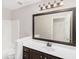 Bathroom featuring dark wood vanity and light countertops with large mirror and toilet at 1085 Crown River Pkwy, Mcdonough, GA 30252