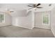 Spacious bedroom featuring neutral walls, carpet, ceiling fans, and ample natural light at 1085 Crown River Pkwy, Mcdonough, GA 30252