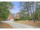 Spacious home featuring an extended driveway, three-car garage, and lush greenery at 1085 Crown River Pkwy, Mcdonough, GA 30252