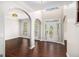 Bright foyer with hardwood floors, arched doorways, and a decorative glass front door at 1085 Crown River Pkwy, Mcdonough, GA 30252
