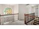 Second-floor hallway with decorative chandelier, carpet, and wrought iron railing at 1085 Crown River Pkwy, Mcdonough, GA 30252