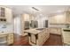 Gourmet kitchen with a center island, granite countertops, and stainless steel appliances at 1085 Crown River Pkwy, Mcdonough, GA 30252