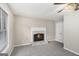 Inviting living room featuring a marble fireplace, ceiling fan, and neutral carpet at 1085 Crown River Pkwy, Mcdonough, GA 30252