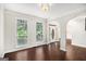Spacious living room with hardwood floors and large windows allowing for natural light at 1085 Crown River Pkwy, Mcdonough, GA 30252