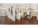 Spacious open concept showing hardwood floors, kitchen, and a staircase at 1085 Crown River Pkwy, Mcdonough, GA 30252