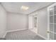 Room with neutral carpet, and a tile floor bathroom can be seen through the doorway at 1085 Crown River Pkwy, Mcdonough, GA 30252