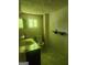 Bathroom featuring a toilet, small vanity and mirror with a small shelf to the side at 4 Maple St, Porterdale, GA 30014