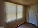 Bedroom featuring a window, front door and flooring at 4 Maple St, Porterdale, GA 30014