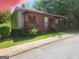Charming home with a welcoming porch, red trim, and landscaping at 4 Maple St, Porterdale, GA 30014
