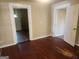 The living room has hard wood floors and two doorways leading to other rooms at 4 Maple St, Porterdale, GA 30014
