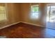 Living room with wood floors and natural light from two windows at 4 Maple St, Porterdale, GA 30014