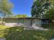 Backyard featuring a patio, green grass, gray siding, and a window at 9022 Homewood Dr, Riverdale, GA 30274