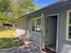 Backyard featuring a patio, green grass, gray siding, and a window at 9022 Homewood Dr, Riverdale, GA 30274