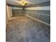 Finished basement with gray walls, white trim, tile floors, and a ceiling fan at 9022 Homewood Dr, Riverdale, GA 30274