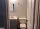 Modest bathroom with simple mirror, toilet, and vanity at 9022 Homewood Dr, Riverdale, GA 30274
