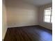 Empty bedroom showcasing hardwood floors and a bright window at 9022 Homewood Dr, Riverdale, GA 30274
