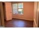 Small, empty bedroom featuring hardwood floors and a window at 9022 Homewood Dr, Riverdale, GA 30274