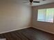 Empty bedroom showcasing hardwood floors and a bright window at 9022 Homewood Dr, Riverdale, GA 30274