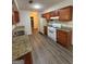 Traditional kitchen featuring wood cabinets, granite countertops, and modern appliances at 9022 Homewood Dr, Riverdale, GA 30274