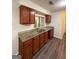 Traditional kitchen featuring wood cabinets, granite countertops, and modern appliances at 9022 Homewood Dr, Riverdale, GA 30274