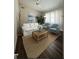 Bright living room featuring hardwood floors, neutral walls, white sofa, and bright decor at 9022 Homewood Dr, Riverdale, GA 30274