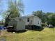 The backyard features a storage shed and fencing for privacy, with a grill ready for outdoor cooking at 3143 S West St, Covington, GA 30014