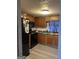 Efficient kitchen with black appliances and wood cabinets at 3143 S West St, Covington, GA 30014