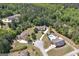 Expansive aerial view showcasing a home with a long driveway, lush landscaping, and mature trees at 330 Noah Pl, Mcdonough, GA 30252