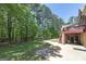 Spacious backyard with a concrete patio, mature trees, and lush green grass at 330 Noah Pl, Mcdonough, GA 30252