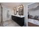 Bathroom with double vanity, dark wood cabinets, large mirrors and walk-in shower at 330 Noah Pl, Mcdonough, GA 30252