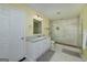 Tiled bathroom with walk-in shower, tile floors, and white vanity at 330 Noah Pl, Mcdonough, GA 30252