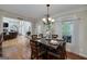 Elegant dining room with a modern chandelier and a view to the living room and the backyard at 330 Noah Pl, Mcdonough, GA 30252
