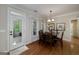 Cozy dining room featuring a modern chandelier and an adjacent screened-in porch at 330 Noah Pl, Mcdonough, GA 30252