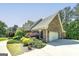 Brick home with a side-entry garage and lush landscaping at 330 Noah Pl, Mcdonough, GA 30252