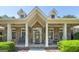 Charming brick home featuring a welcoming front porch with seating and well-manicured landscaping at 330 Noah Pl, Mcdonough, GA 30252