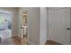 Inviting hallway featuring hardwood floors and access to a well-lit laundry room and half bathroom at 330 Noah Pl, Mcdonough, GA 30252