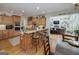 Open-concept kitchen featuring granite countertops, a breakfast bar, and access to the living room at 330 Noah Pl, Mcdonough, GA 30252