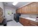 Functional laundry room equipped with cabinets, utility sink, washer, dryer and exterior access at 330 Noah Pl, Mcdonough, GA 30252