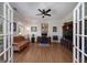 Comfortable living room with hardwood floors, a ceiling fan, and ample natural light at 330 Noah Pl, Mcdonough, GA 30252